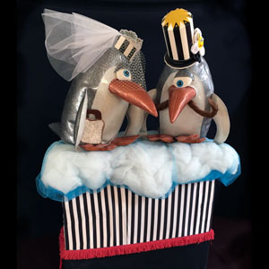 mini pull float of two penguins dressed like a bride and groom by K.S. Lewis